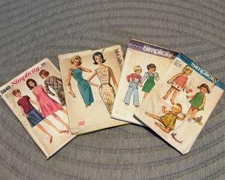 Vintage sewing patterns, notions and sewing machine.