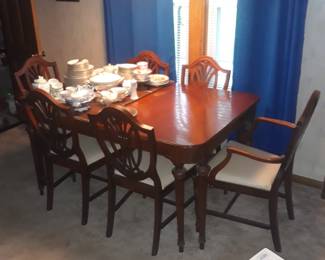 Dining table with nice shield back chairs. In real nice condition.  With table leaves and pads.