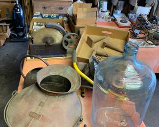 Primitive items including copper spouted pot, glass jug, and copper watering can 