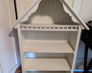 Adorable bookcase designed as if a doll house. I used it for books on the lower shelfs and displayed winsome scenes in the attic" portion.