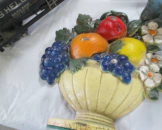 Iron doorstop in the form of a basket filled with fruit