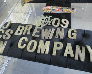 Brass letters from the facade of the OLD Jackson Brewing Company building  on Decatur Street. 