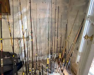 Lots of fishing rods and fishing gear.