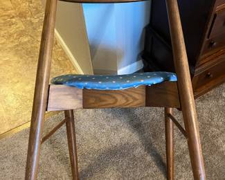 A separate chair has a back rung missing