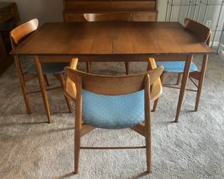 Stanley Fine Furniture.  Walnut table with rosewood trim on each end. Table leaf box dated 1961.  Table has extra leaf, complete table pads & 4 cat eye chairs: 1 arm chair and 3 regular chairs  