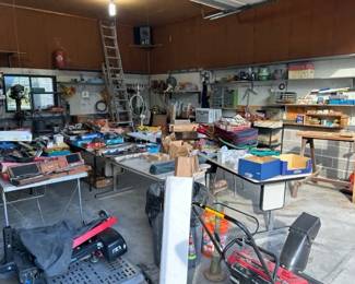 Full garage. Snow blower. Edger. Scooter lift for vehicle. 