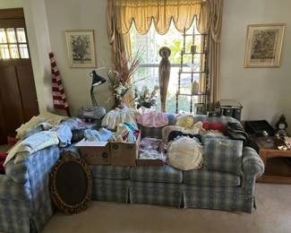 Couch loveseat. Religious figurine.  