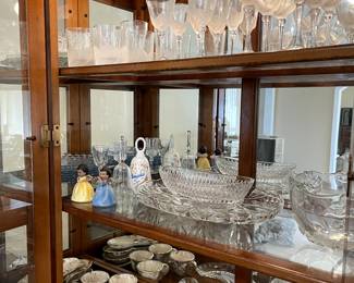 Crystal with lighted china cabinet and matching dining room table.