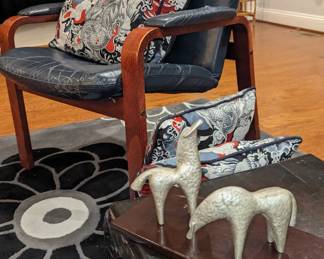 The blue chair has sold the rugs and the mid century horses have not