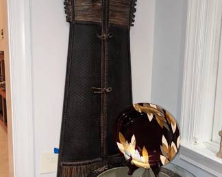 There are a pair of beautiful amari fish pots with stands and cut glass tops. Hanging is a replica of Japanese tribal dress