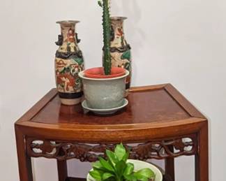 Beautiful wood block print of Buddha. Two carved nesting tables with burl tops. A pair of stamped vases. One has been repaired. Both have minor chipping. To Celadon flower pots.