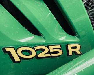 John Deere 1025-R Sub-Compact Utility Tractor with 60D Autoconnect Mid Mount Side Discharge Mower, Rear Mount Box Blade, Fixed Ting Pallet Loader and 120-R Front End Loader. 16 FT Bumper Pull Flatbed Trailer.