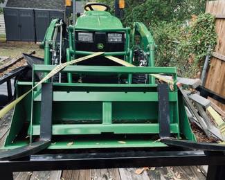 John Deere 1025-R Sub-Compact Utility Tractor with 60D Autoconnect Mid Mount Side Discharge Mower, Rear Mount Box Blade, Fixed Ting Pallet Loader and 120-R Front End Loader. 16 FT Bumper Pull Flatbed Trailer.
