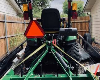 John Deere 1025-R Sub-Compact Utility Tractor with 60D Autoconnect Mid Mount Side Discharge Mower, Rear Mount Box Blade, Fixed Ting Pallet Loader and 120-R Front End Loader. 16 FT Bumper Pull Flatbed Trailer.