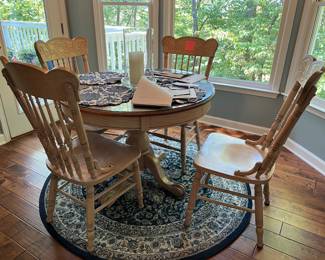 Nice redone oak breakfast table with round protective glass top and 4 chairs. Extra leaf as well!