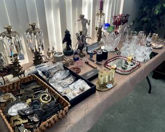 Lots of beautiful prism enhanced candle holders, crystal items, and a basket of brass belt buckles!