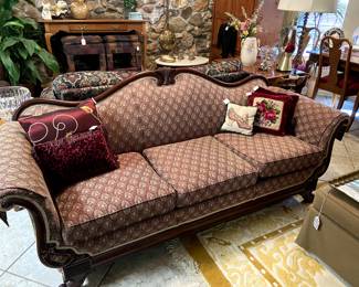 This is one of several sofas.  Carved wood camel back with burgundy print upholstery.