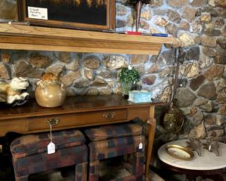 This foyer table can store these cool stools for extra seating when needed.