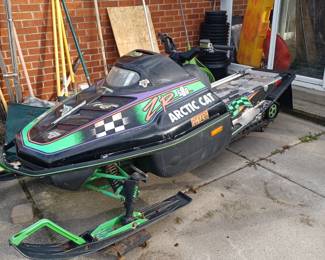 Artic Cat snowmobile - The seat and windshield are included.