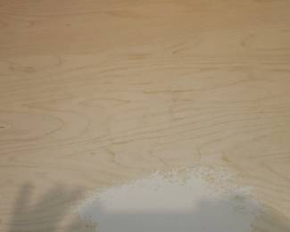 Slight wear on top of white desk