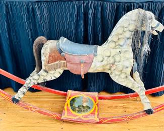 Antique primitive wooden rocking horse with horsehair tail and mane.