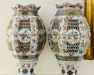 Two famille rose reticulated lanterns and stands.