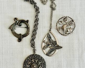 Silver Brooches: Margot de Taxco, Medallion, Wallace 1972 Peace on Earth, Flamingo (left to right)