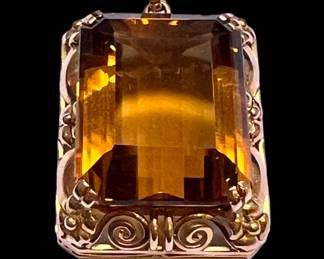 Very large citrine surround by 18k gold scroll mounting