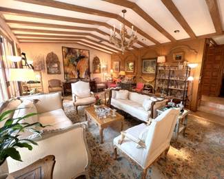 Stunning living room!  Antiques, contemporary art, crystal, antique mirrors, wooden chandelier, palace sized Oriental rug, sofas, Don Ruseau furniture, antique desk