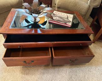 Good condition glass coffee table with storage located in side hearth room 