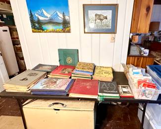 Table full of old scrap books and vintage greeting cards.