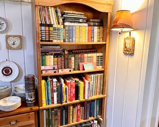 One of two wood bookshelves full of books.  Shelves for sale.
