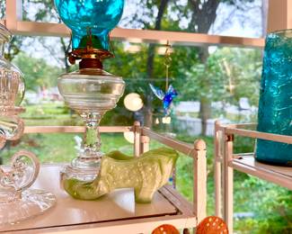 Oil lamp with blue hurricane shade.