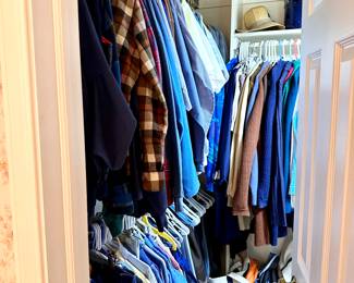 Master closet filled with men's and women's clothing and shoes.
