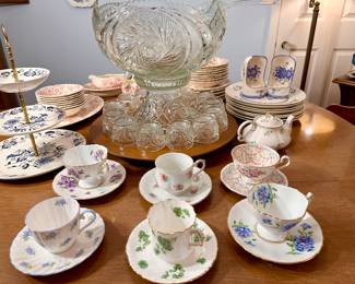 Cut glass punch bowl on pedestal, tea cups and saucers.