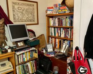 Book cases and books, old fax machine, framed map..