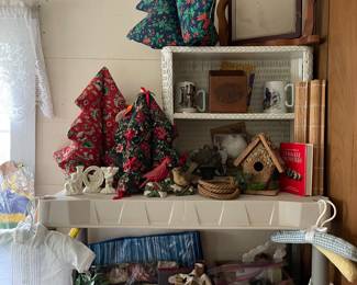 Cloth Christmas trees, vintage picture frame, wicker small shelf, in the pink box on 2nd shelf are bag lots of designer perfume.  