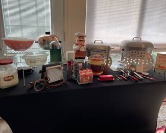 Table full of vintage bake/cooking items 