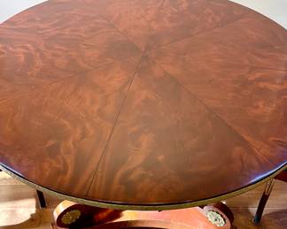 Detailed view of $3500 - Russian neoclassical mahogany pedestal table with brass edging and base accents; close-up of beautiful wood grain on top of the table