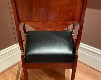 Alternative view of $2000 - Russian neoclassical chair with black, leather seat and gold-gilded accents; view of the wood grain on back side of chairs