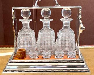 $1800 - Antique Tantalus bar set by Betjemann’s Patent 23968 London - at least 100 years old, with three crystal decanters, 8 crystal glasses, 2 wooden cups, plus the KEY! Excellent condition! Blue tarnish on one side - 15 x 11 x14