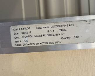 Close up of gallery label on reverse side of “Shift (Red) (Yellow) (Blue)” by Eric Freeman; circa 2017; 20” x 20” unframed; 21” x 21” framed; sold as a suite of 3; original paintings on canvas with artist signature and date on back; framed in brushed chrome metal with black interior space between frame and canvas ($9000 set of 3)