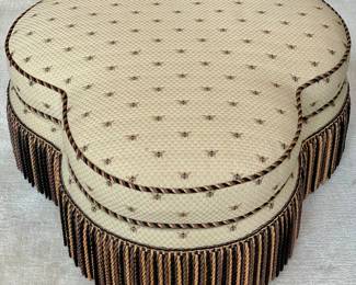SOLD; 40"d x 17"h; custom-upholstered, medallion-shaped ottoman with embroidered bees and tri-color finge