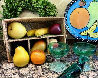 $32; eight pieces of vintage ceramic fruit.                                                          $28; boxwood wreath.                                                                                                       $22; utensil and napkin basket.                                                                      $100; 4"h; green Lalique bird.