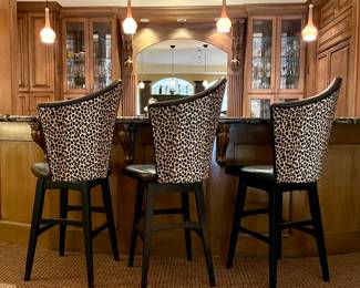 SOLD each (3 available); 21 x 21 x 52; animal print and leather, asymmetrical, rotating bar stool