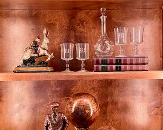 SOLD each (2 available); 12 x 8 x 10; green and black craquelure finish metal planters with gold design and gold lion's head handles including greenery.                                                         SOLD; 11"h; monkey riding rabbit decor.                                                   $22; 7"h; set of 4 wine glasses with "W" etchings.                                 $24; 13"h; vintage etched glass decanter.                                                                                    SOLD; 16"h; metal golf sculpture by Austin Prop from the Vintage Golfing Collection.                                                                                        $48; 18"h; globe-like decor on pillar, made in the Philippines.                                                                                                                $38; 11"h; globe-like decor on pillar, made in the Phillippines.                    