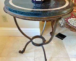 $280; 22"d x 27"h; tessellated, natural-stone top table with scrolled, metal legs; made in the Phillipines