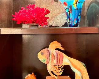 $38; 11 x 8; faux red coral and acrylic stand.                                                    $28 each (2 available); approx 18" w; coral leaf.                                                                $50; 9"d x 10"h; art glass blue vase.                                                                                                              $12 each (2 available); conk shell.                                                                                                                              $120; 18 x 15; fish sculpture