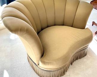 $1200; 62 x 44 x 38; Marge Carson designed, asymmetrical, curved chair with nail-head trip and fringe skirt