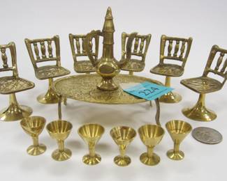 LARGE SCALE DOLL HOUSE BRASS FURNITURE: LOW TABLE, SIX STOOLS, EWER AND SIX STEMS